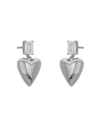 Heart-shaped silver earrings with clear gemstones on a white background