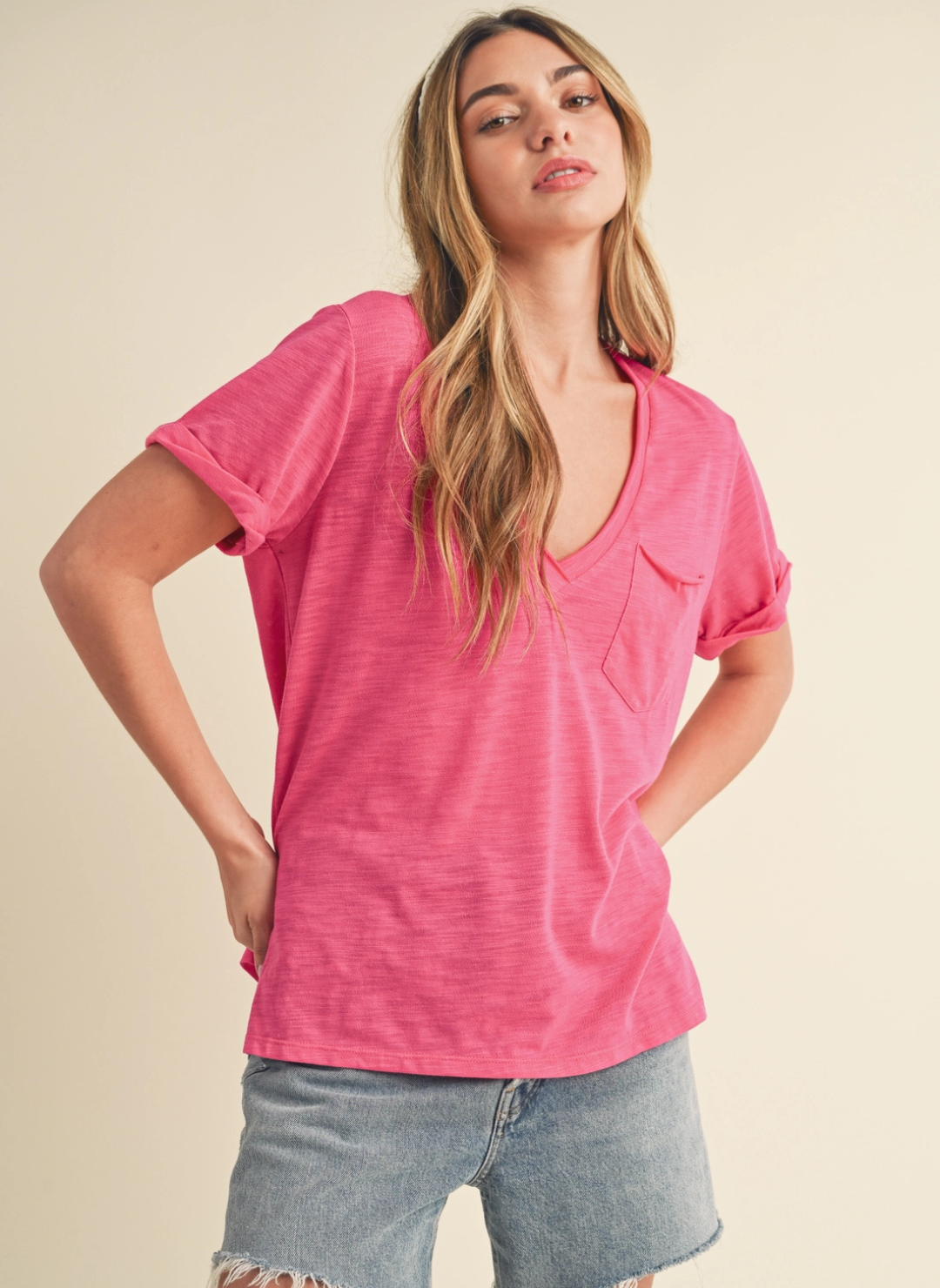 Front view of model wearing the Sweetness Slub V-Tee paired with denim pants. Model is standing in front of white background. 