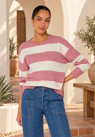 Velvet Heart Cornell Sweater on a model with her hair slicked back, blue jeans and her hand on her hip.  