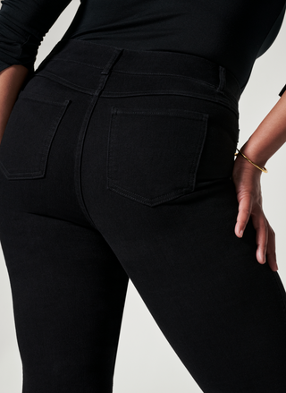 Close up back view of SPANX black denim jeans.