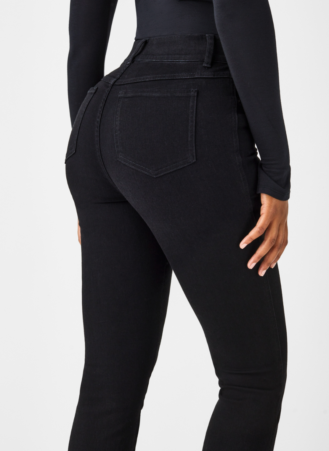 Close up back view of SPANX black denim jeans.