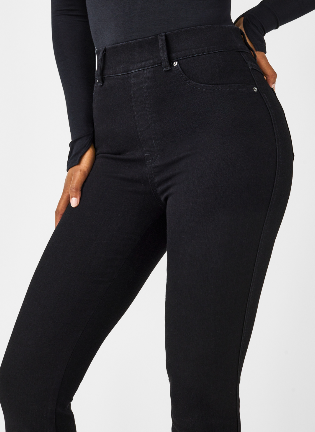 Close up front view of SPANX black denim jeans. 