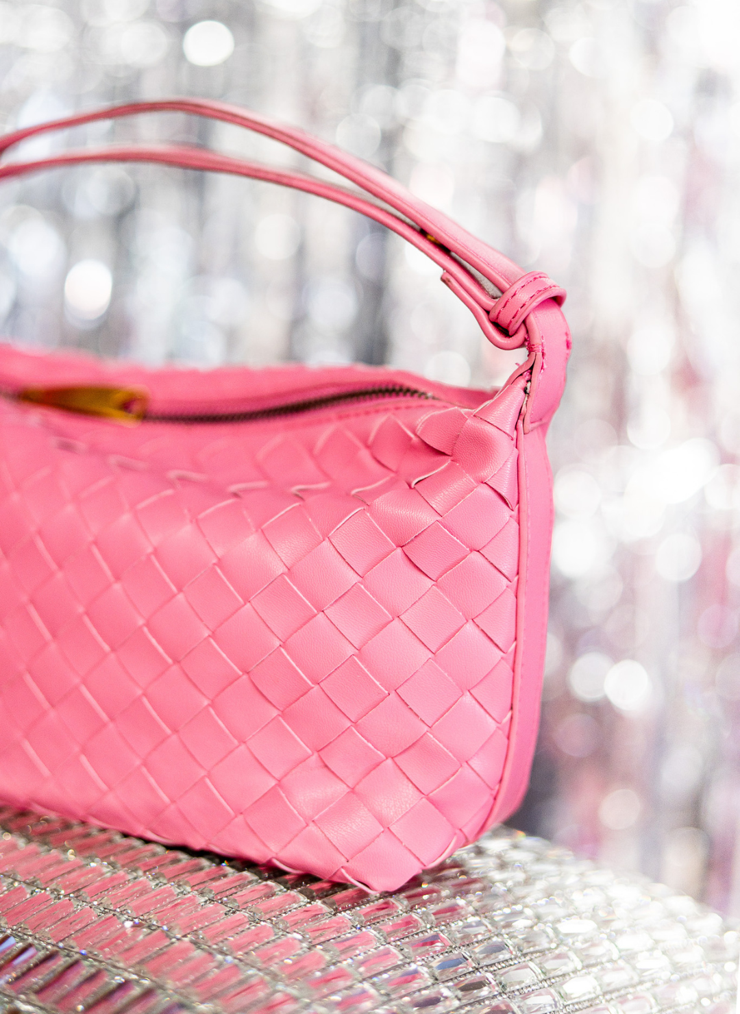 Image shows a close up of the pink leather weave bag.