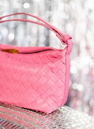 Image shows a close up of the pink leather weave bag.