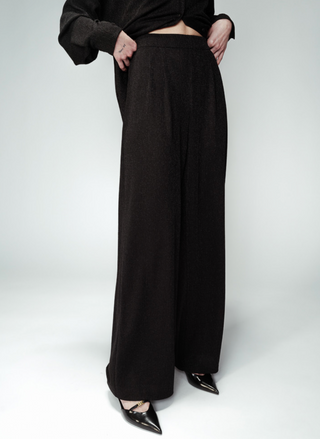 Full view of model wearing the Grace & MilanOpium Knit Lurex Pants paired with the matching top. Model is standing in front of white background.