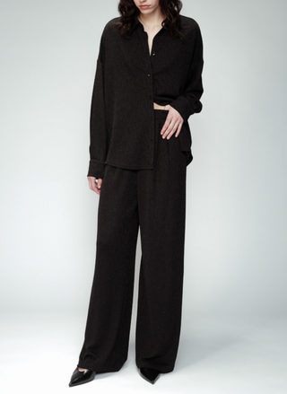 Full view of model wearing the Grace & MilanOpium Knit Lurex Pants paired with the matching top. Model is standing in front of white background.