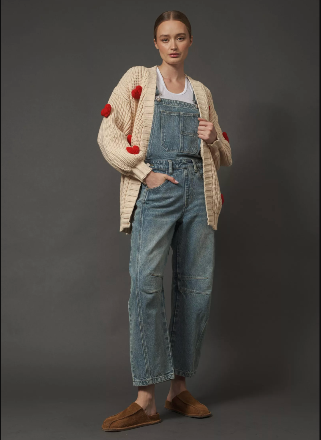 Model is wearing Big Love Cardigan with one have in the overalls she’s wearing under the cardigan.