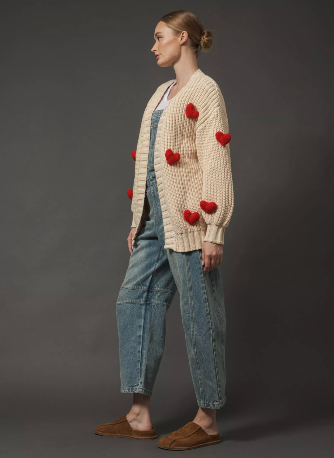 Model is turned to the side showing the side view of the Big love Cardigan 