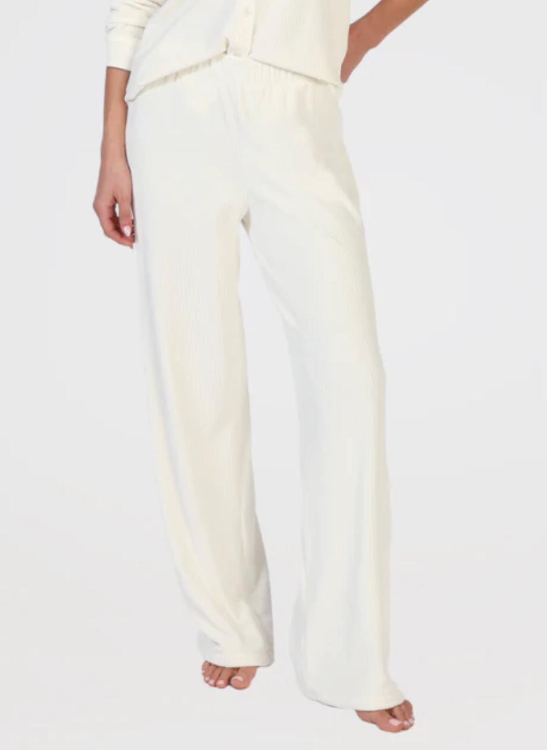 Front view of ribbed white pants. White background.
