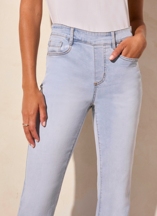 full front view of the model wearing the Tribale Audrey Flare Jeans. Model is standing in front of a white background.