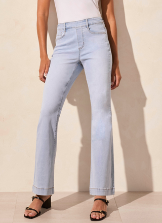 full front view of the model wearing the Tribale Audrey Flare Jeans. Model is standing in front of a white background.