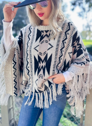 Front view of model wearing Prairie Moon Knit Tassel Top. 