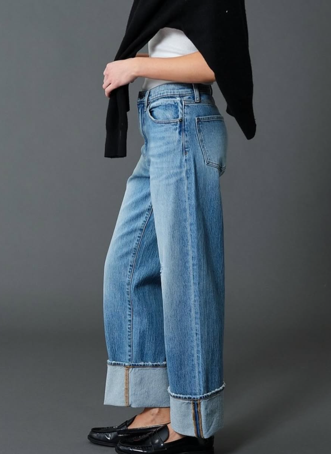 Side view of model wearing the DAZE Eastside High Rise Cuff Denim