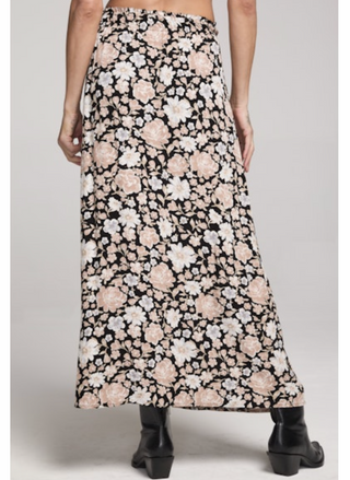 Floral patterned skirt worn by a person on a plain background