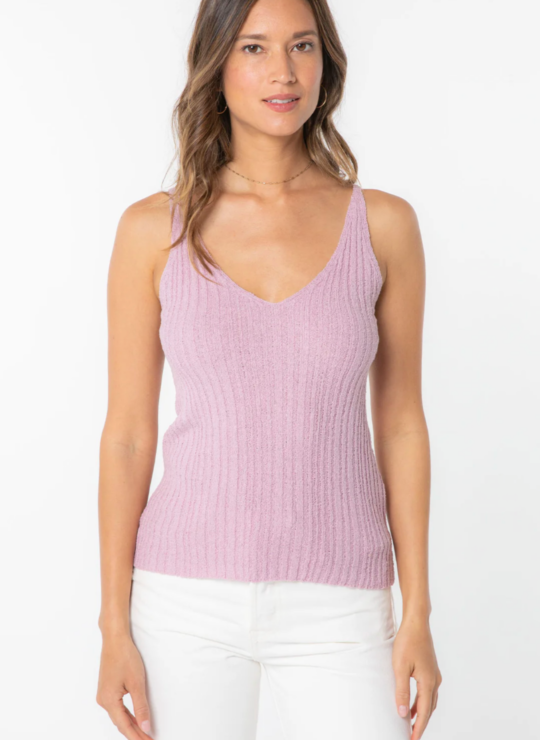 Front view of model wearing the Sheena Sweater Knit Rib Tank paired with white pants. Model is standing informs of white background.