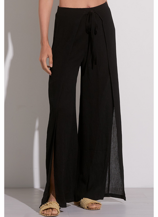 Woman wearing white cotton gauze wide leg wrap pants with tie front and knee-high side slit – lightweight summer pants for women