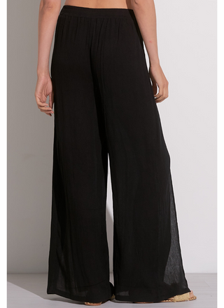 Back view of woman wearing white cotton gauze wide leg wrap pants with tie front and knee-high side slit – lightweight summer pants for women