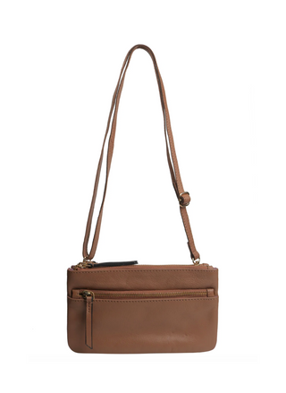 Tan upcycled leather crossbody bag by RISA with front zipper pocket, adjustable strap, and gold hardware – available at August Boutique Ripon.