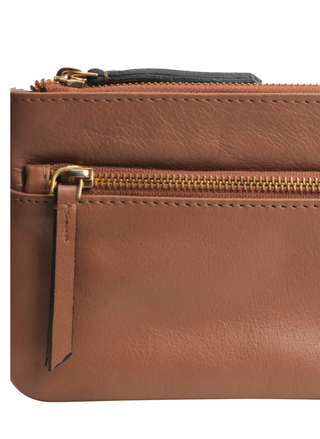 Tan upcycled leather crossbody bag by RISA with front zipper pocket, adjustable strap, and gold hardware – available at August Boutique Ripon.