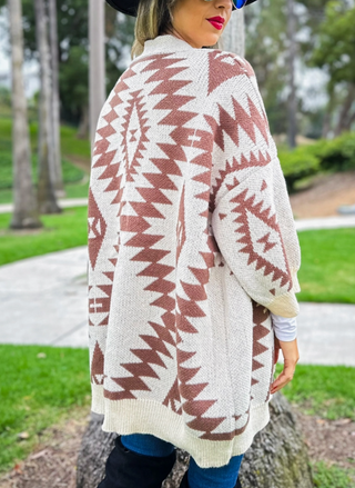 Back view of southwestern printed cardigan. Model is turned around to show the detailed print on the cardigan.