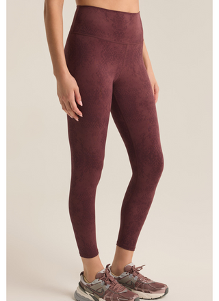 Model is showing side view of leggings, paired with running shoes!