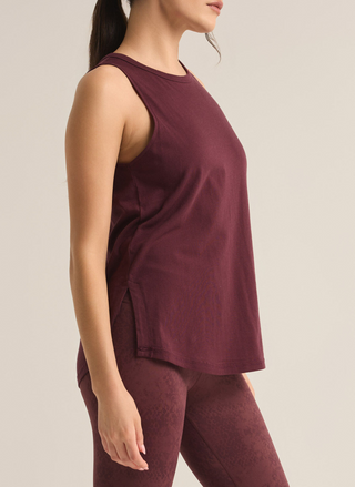 Model is showing a side view of tank top, wearing burgundy leggings that go great with the tank!