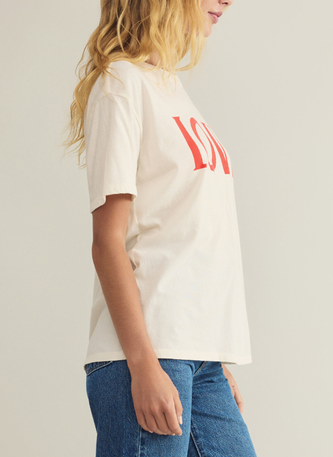 Model is wearing cream colored Big Love BF tee. Model is turned to the side, showing the sleeve length. 