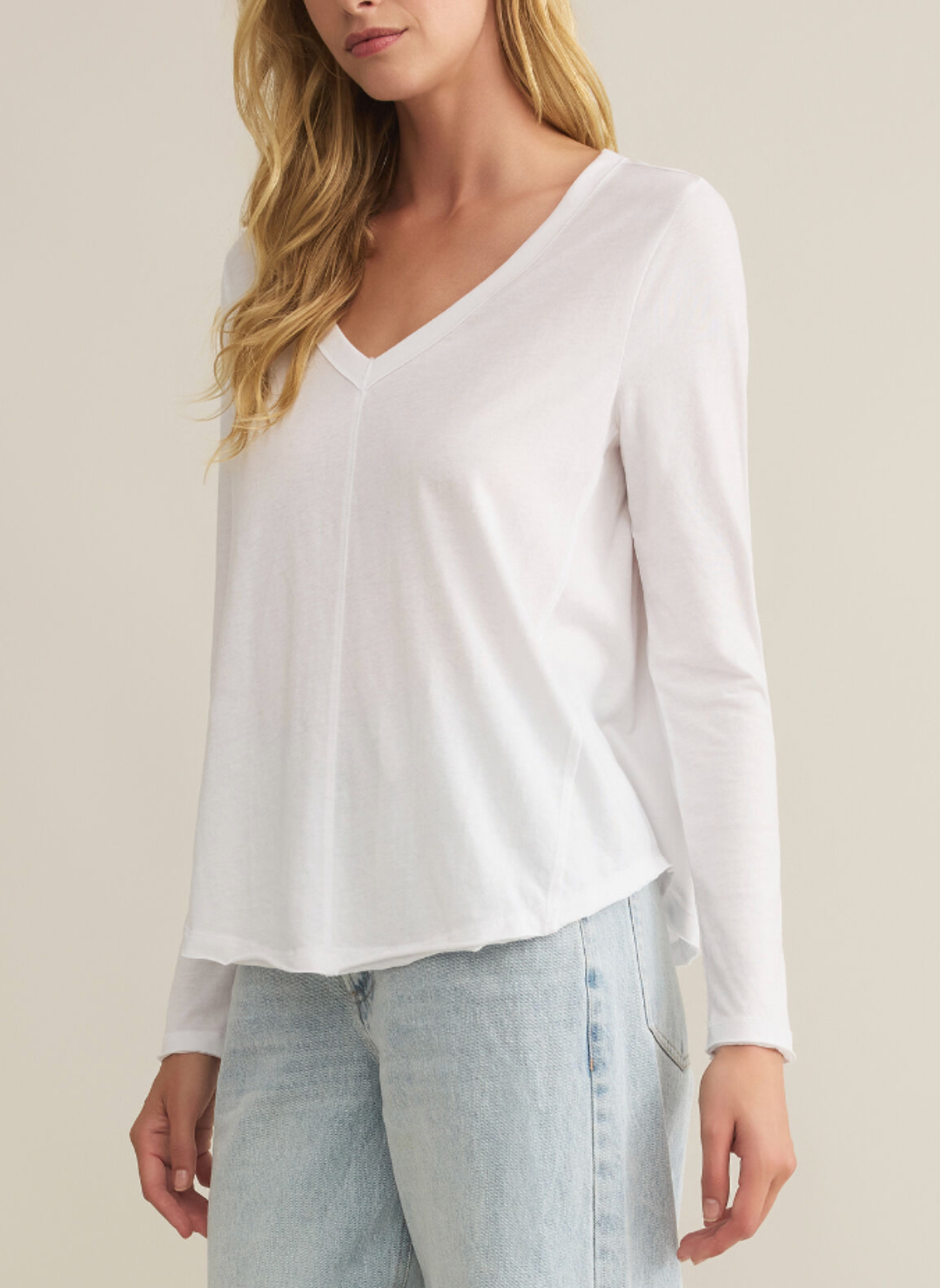 Front view of model wearing white long sleeve Vail LS Tee.