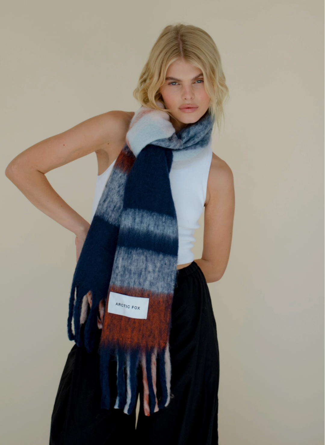 Model is wearing blue, red, and white colored scarf.