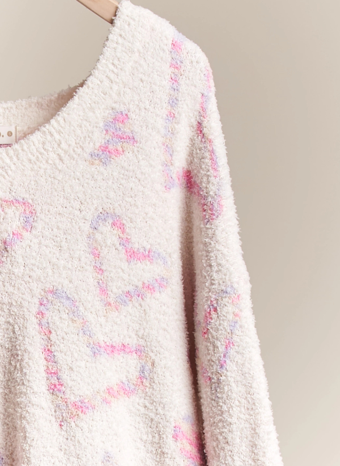 Up close view of the Sweet Heart Sweater in front of white background.