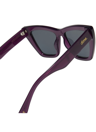 Image shows close up side view of purple and grey polarized sunglasses.