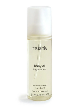 Mushie Baby Oil fragrance-free 145 mL bottle with a clear pump dispenser and minimalist cream label, designed for gentle baby skincare