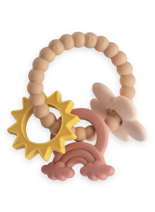 Mushie Nature Teething Ring in neutral earthy tones, featuring a textured silicone ring with attached sun, rainbow, and daisy-shaped teething charms