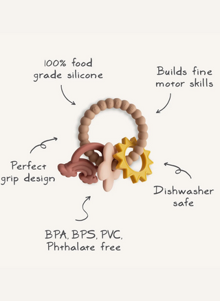 Mushie Nature Teething Ring shown with its sun, rainbow, and daisy charms, highlighting the textured silicone surfaces designed for sensory exploration