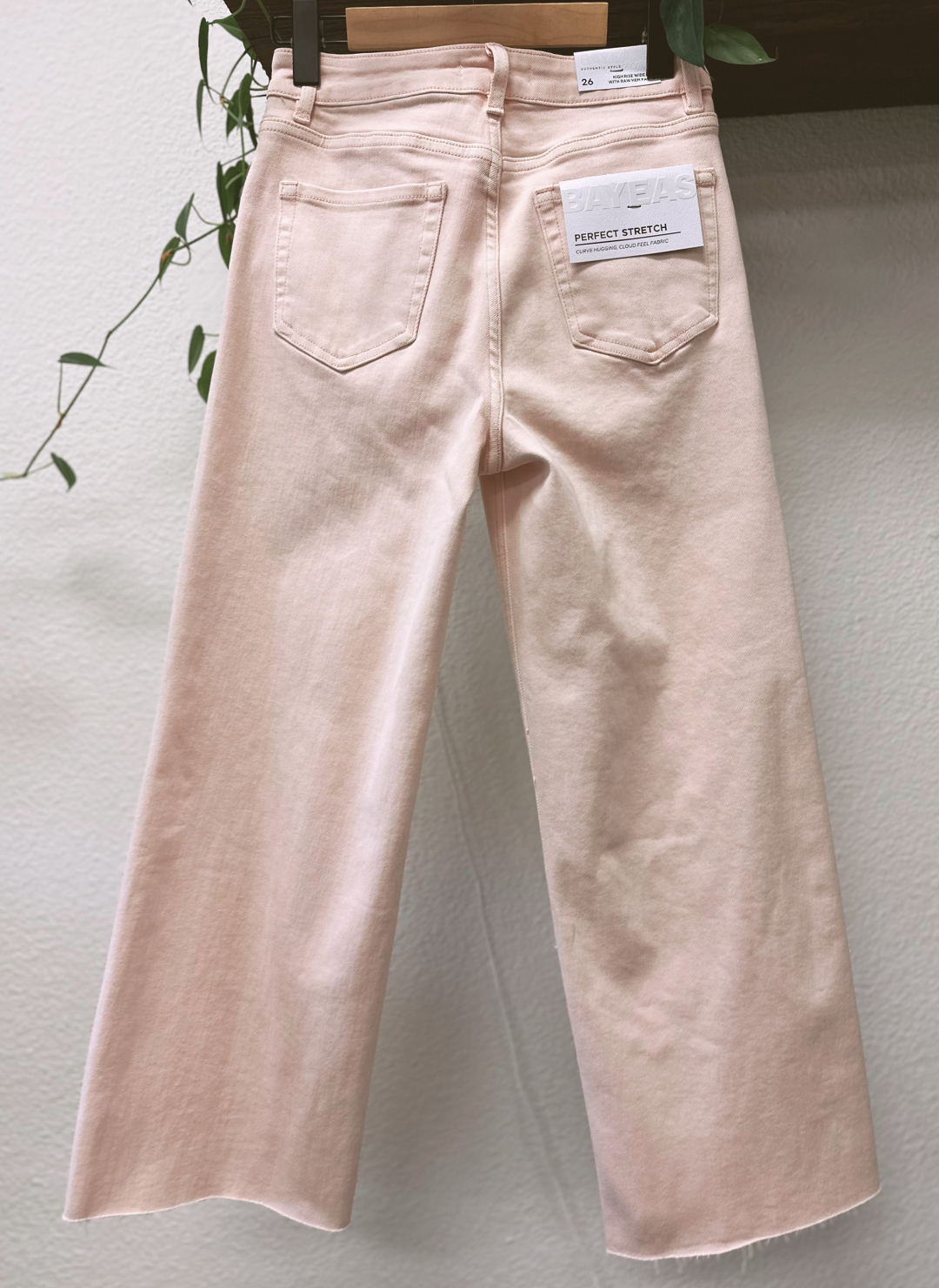 Light pink jeans with a brand tag on a light gray background