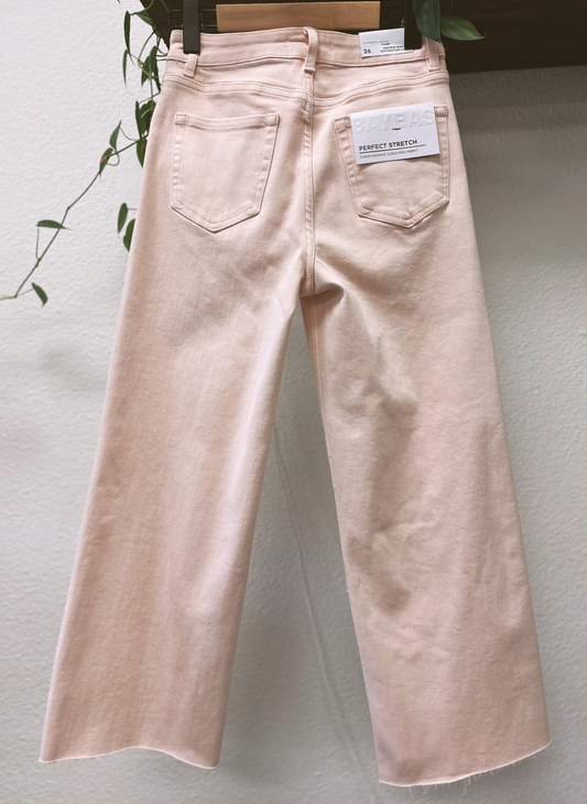 Light pink jeans with a brand tag on a light gray background