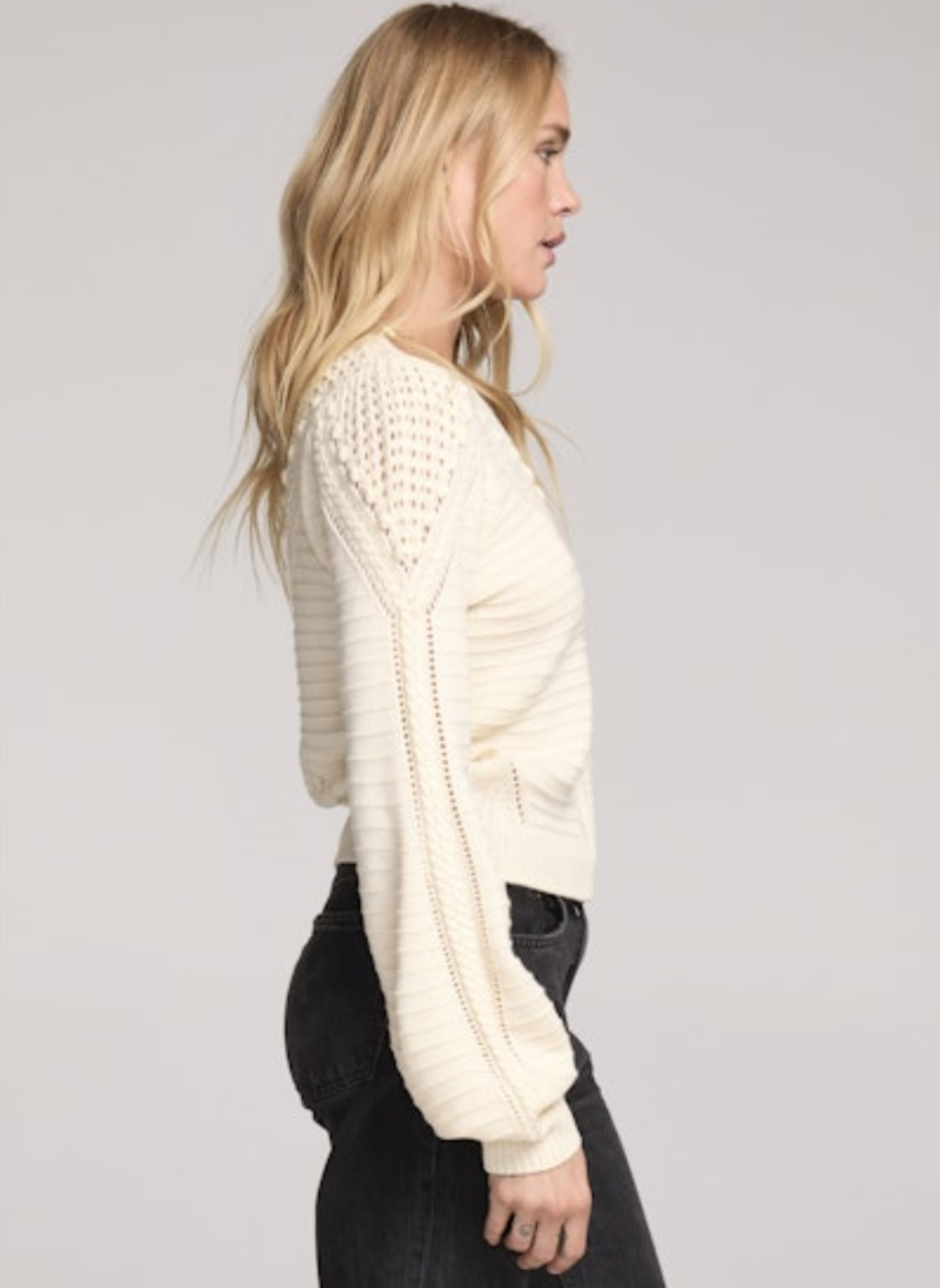 Side profile of Saltwater Luxe Gianny Sweater in cream highlighting textured knit and voluminous sleeve shape.