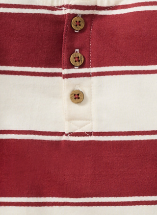 Close-up of wooden button detail on Burt’s Bees Baby holiday striped organic romper