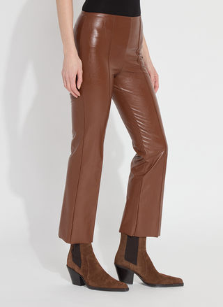 Brown leather pants worn by a person on a white background