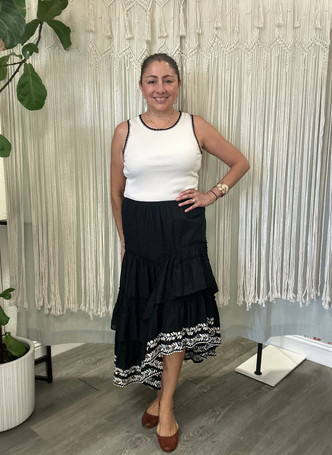 Woman wearing Talisman Sassy Skirt with high-low hem and cream embroidery.