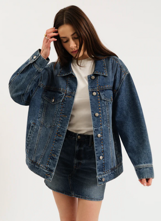 Model wearing oversized Daze Denim Beau Jacket with a white tee and denim skirt, front view