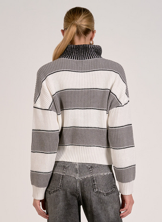 Back view of woman wearing Elan Hearthside Stripe Pullover with bold gray, ivory, and black stripes.