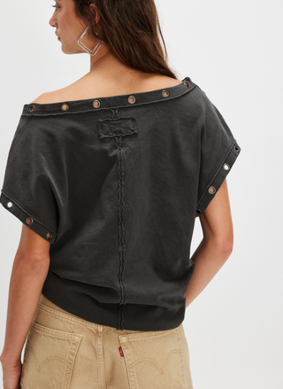 Back view of Free People Billie Tee with raw seam detail and grommet hardware on sleeves