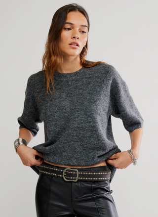 Front view of Free People Margot Sweater Tee in charcoal gray styled with leather pants.