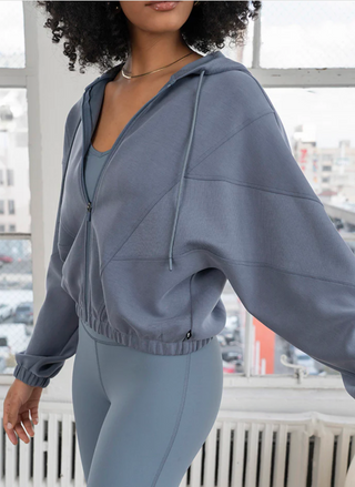 Model wearing Thrive Société Ultraluxe Oversized Hoodie in blue-grey front view
