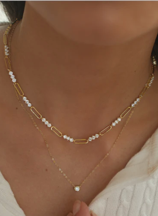 Layered 18k gold Marisol Pendant necklace with cubic zirconia bezel on model”