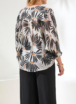 Back view of Tribal floral blouse showing flowing dolman sleeve design and relaxed silhouette in black and white pattern