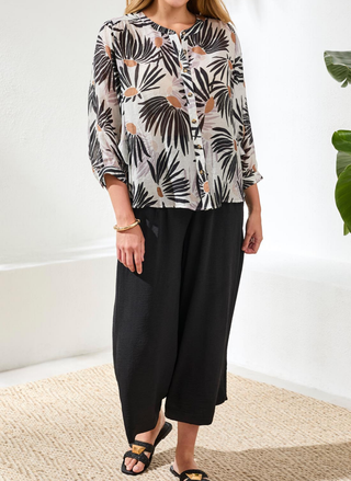 Front view of Tribal Daisy Flowy Dolman Sleeve Blouse in white and black floral print featuring 3/4 sleeves and round neckline