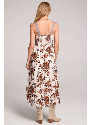 Back view of woman wearing Saltwater Luxe Costa Midi Dress in cream floral print front view.