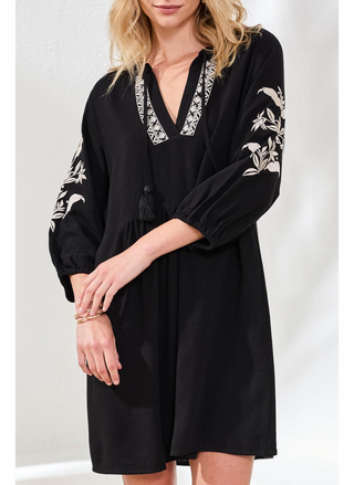 Black dress with floral embroidery on a plain background